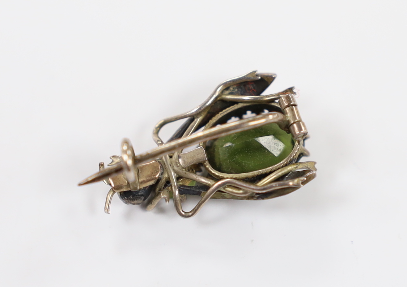A late Victorian gilt white metal and green paste set bug brooch, 23mm.